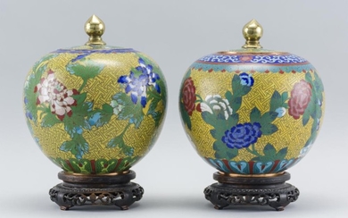 PAIR OF CHINESE CLOISONNÉ ENAMEL COVERED JARS In ovoid form, with a floral design on a yellow fretwork ground. Heights 7.5". Include...