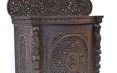 A 19th century Anglo-Indian (?)padouk side cabinet, the intricately carved...