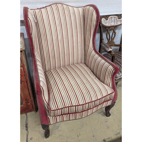 A 19th century Louis XVI style upholstered wing armchair, wi...