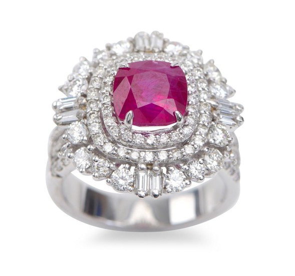 A BURMESE RUBY AND DIAMOND CLUSTER RING - Featuring a cushion cut ruby weighing 3.12cts, with diamonds to the surround and shoulders...