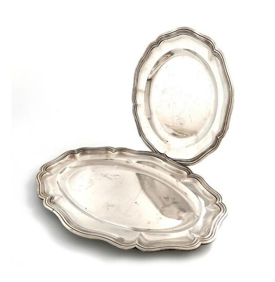 A French silver platter, circular form, moulded border, diameter 33cm, plus another silver meat platter, with a French import mark and retailed by P. Fenninger, shaped oval form, moulded border, length 45cm, approx. total weight 67oz. (2)