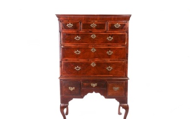 A George II walnut chest on stand, with diagonal crossbandin...