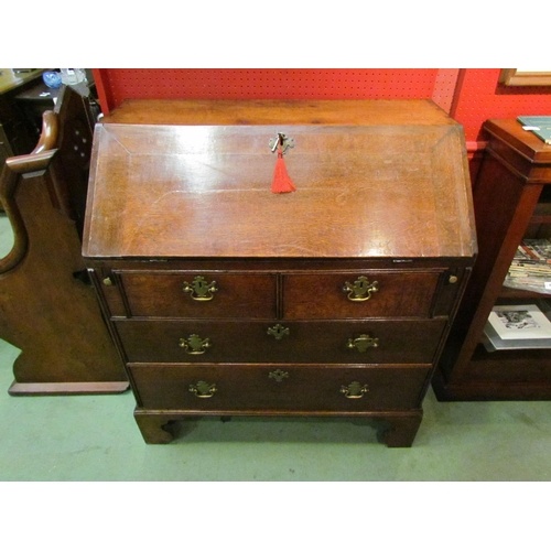 A George III country oak bureau with fitted interior over tw...