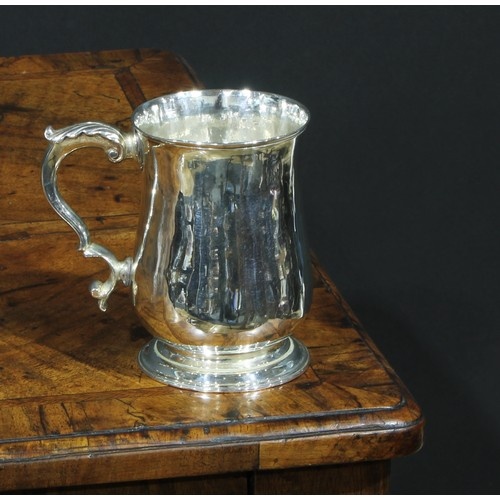 A George III silver bell shaped half pint mug, foliate scrol...