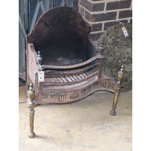 A George III-style brass mounted cast iron serpentine fire g...