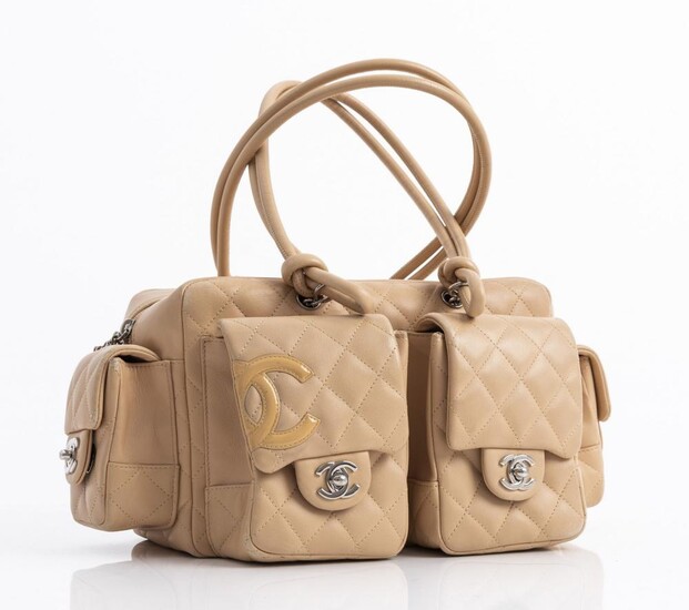 A HANDBAG BY CHANEL Styled in beige quilted leather with silver metal hardware, 16 x 34 x 14cm.