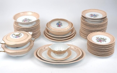 A Limoges Charles Ahrenfeldt part dinner service, mid 20th century, in salmon pink with gilt borders and central floral design, comprising: thirty four dinner plates 24.5cm diameter, twelve lunch plates, two tureens and covers, a sauce dish with...