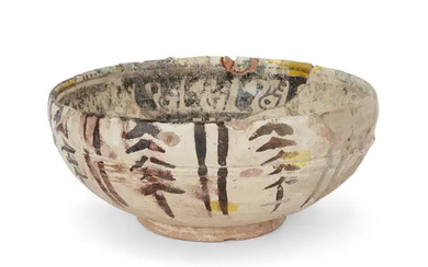A Nishapur yellow, green and black painted pottery bowl, Central Asia, 11th...
