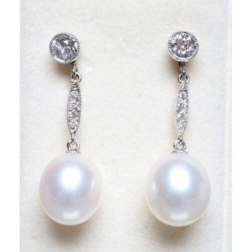 A PAIR OF DIAMOND AND PEARL DROP EARRINGS, the solitaire 18c...