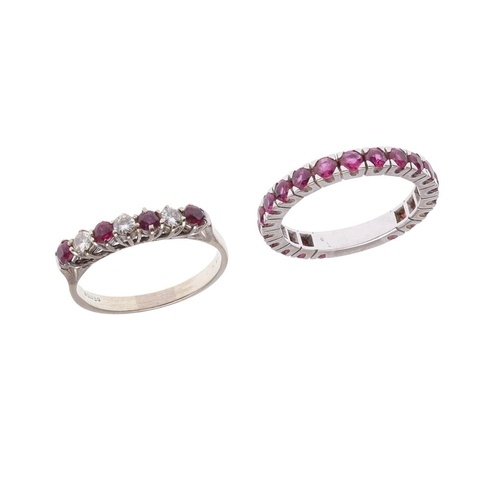 A RUBY AND DIAMOND HALF HOOP RING. mounted with four circula...