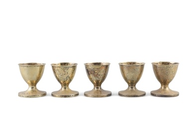 A SET OF FIVE GEORGE III SILVER GILT EGGS CUPS, London c.1...