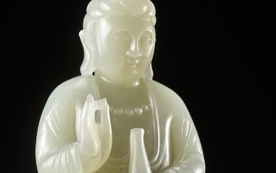 A SMALL PALE CELADON JADE FIGURE OF GUANYIN, QING DYNASTY