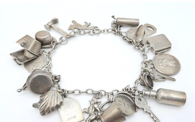 A Sterling Silver Charm Bracelet with 23 Charms. 18cm length...
