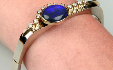 A black opal and brilliant-cut diamond hinged bangle.