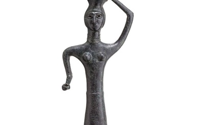 A bronze statue of a woman with a vessel on her head, Bactrian, late 3rd - early 2nd millenium B.C.
