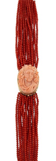 A coral sautoir necklace with coral cameo clasp, composed of seventeen rows of coral corallium rubrum uniform beads to an oval coral cameo clasp depicting the head of Flora, clasp stamped 750, approx. length 74cm