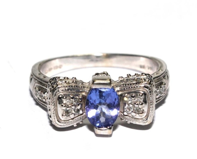 A diamond and tanzanite white gold ring set in 14 carat gold