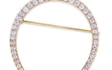 A diamond brooch designed as a horseshoe set with...