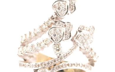 A diamond set dress ring of crossover design.