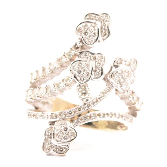 A diamond set dress ring of crossover design.