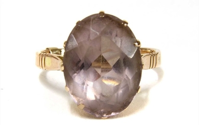 A gold single stone amethyst ring