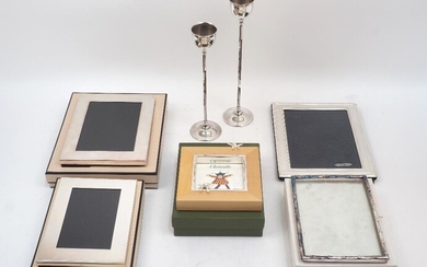 A group of five silver plated photo frames, including: two cased Links examples and one Christofle example, together with a pair of Italian silver plated candlesticks, designed with thin hexagonal stems to circular feet and rounded capitals, one...
