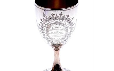 A hallmarked silver trophy goblet engraved with floral detai...