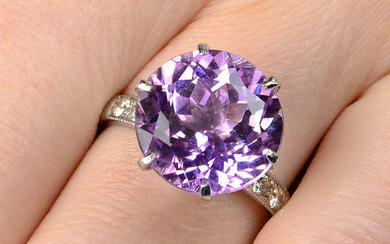 A kunzite single-stone ring, with diamond shoulders.