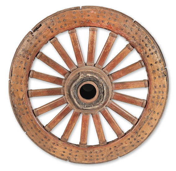 A large turned Chinese carved hardwood and iron bound ceremonial carriage wheel