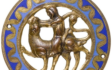 A late Romanesque gilt bronze and champlevé enamelled French plaque of Samson fighting the lion