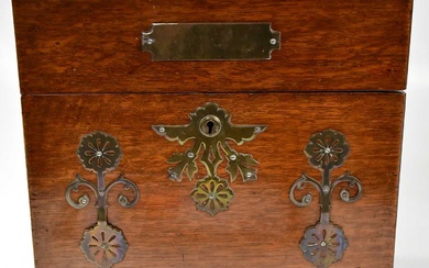 A late Victorian brass mounted oak cased tantalus and games...