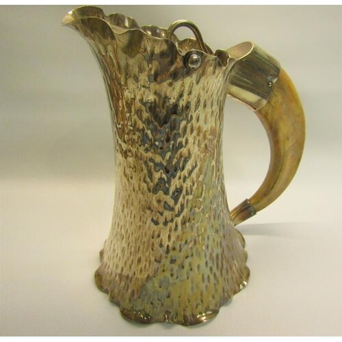 A late Victorian silver plated ale jug of beaten tapering sp...