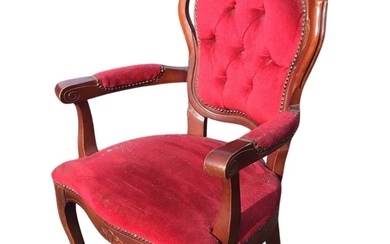 A mahogany armchair, the button upholstered back with carved crest...