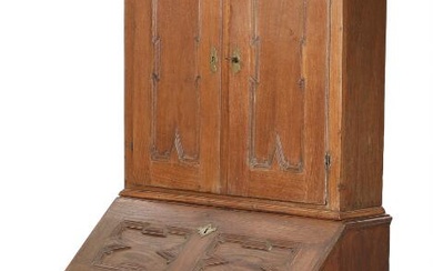 A mid 18th century Baroque oak bureau, front with two doors behind...