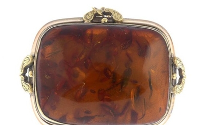 A modified amber brooch.Length 5cms. Total weight 24.6gms....
