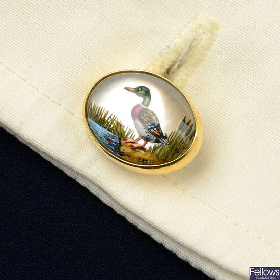 A pair of 18ct gold reverse-carved and painted rock crystal cufflinks, depicting a mallard duck and pheasant, by Deakin & Francis.