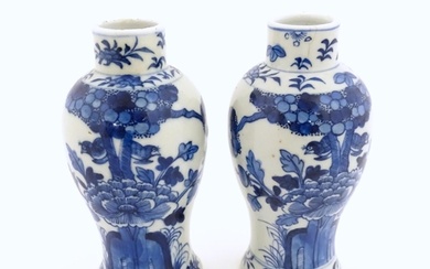 A pair of Chinese blue and white vases decorated with flower...