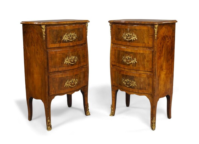 A pair of French burr walnut serpentine front bedside commode chests, 18th century, with walnut crossbanding, three drawers, ormolu mounts, raised on splayed legs, 87cm high, 52cm wide, 36cm deep