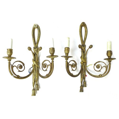 A pair of French gilt metal wall sconces, twin branch with s...