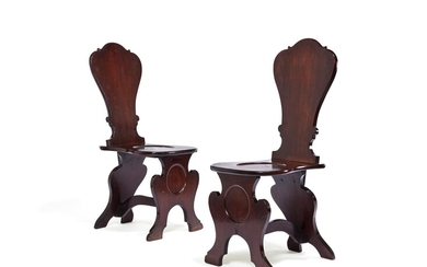 A pair of George II mahogany hall chairs