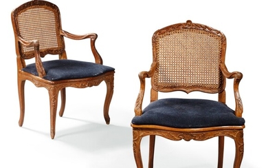 A pair of carved and caned beechwood armchairs, Louis XV, mid-18th century | Paire de fauteuils en bois de hêtre sculpté et canné, d'époque Louis XV