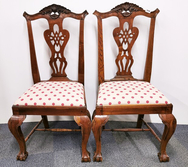 A pair of early 19th century carved walnut side chairs.