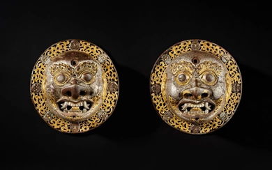 A pair of large gold, silver and copper overlaid iron door bosses, Tibet, 16th / 17th century