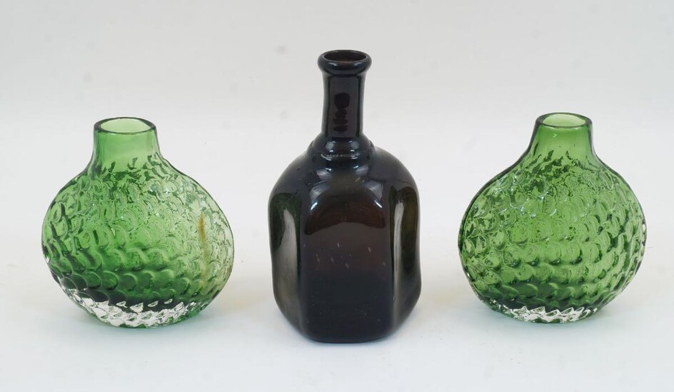 A pair of moulded green glass ‚Äòfish scale‚Äô vases, 20th century, 14cm high; together with a blown hexagonal glass bottle, 18cm high (3)