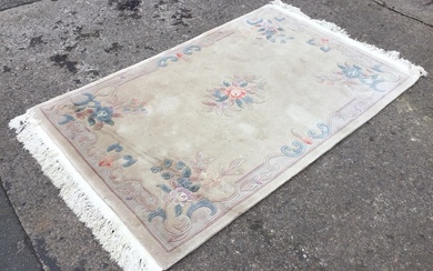 A rectangular Chinese wool aubusson style rug with central floral...