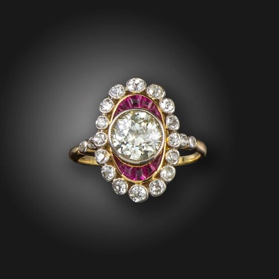 A ruby and diamond cluster ring, centred with an old...