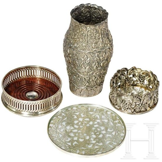 A silver vase, a table trivet and two coasters, circa