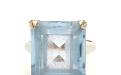 A topaz ring set with a faceted blue topaz, mounted in 18k...
