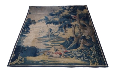 A verdure tapestry, 18th century, depicting two lovers in a woodland scene with a parrot perched on a tree and sheep grazing in the background, later border and repairs, approx. 252 x 224cm