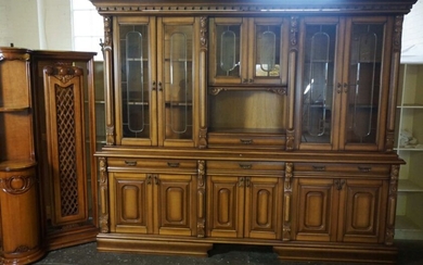 A very large modern varnished dresser, with three glazed panelled cabinets, set on a base with three